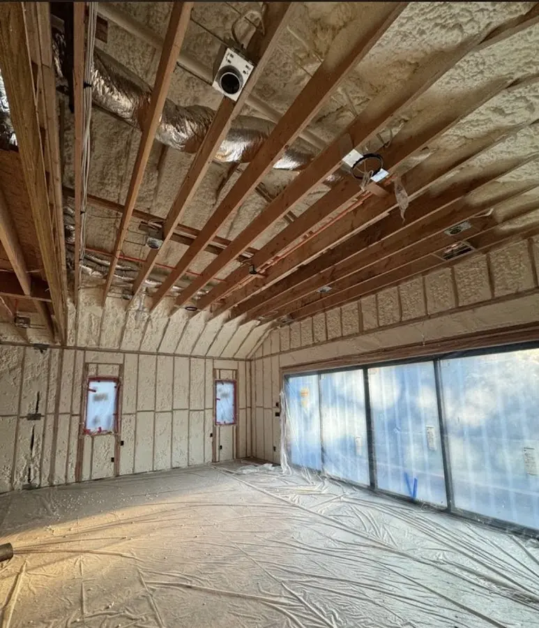Interior walls and ceiling insulated with spray foam during new construction in Barre
